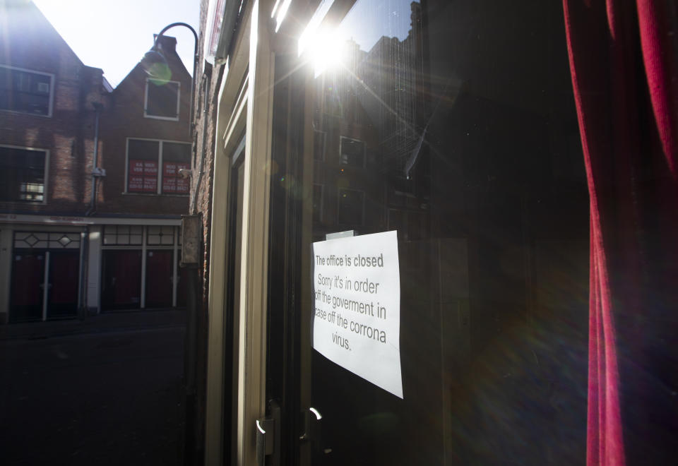 Closed windows of sex workers are seen in the Red Light District of Amsterdam, Netherlands, Monday, March 16, 2020. Health minister Bruno Bruins ordered all Dutch schools, cafes, restaurants coffeeshops, saunas, sex clubs and sport and fitness clubs to be closed from Sunday March 15th onwards as the government sought to prevent the further spread of coronavirus in the Netherlands. For most people, the new coronavirus causes only mild or moderate symptoms, such as fever and cough. For some, especially older adults and people with existing health problems, it can cause more severe illness, including pneumonia. (AP Photo/Peter Dejong)