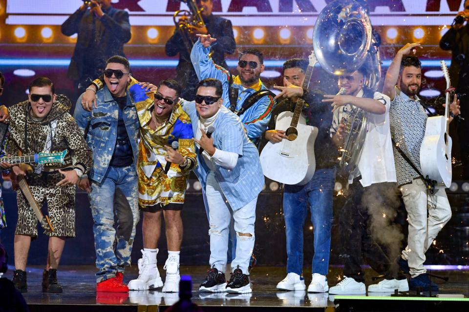 Marca MP and Grupo Firme perform onstage at Premios Juventud 2021 at Watsco Center on July 22, 2021, in Coral Gables, Florida.