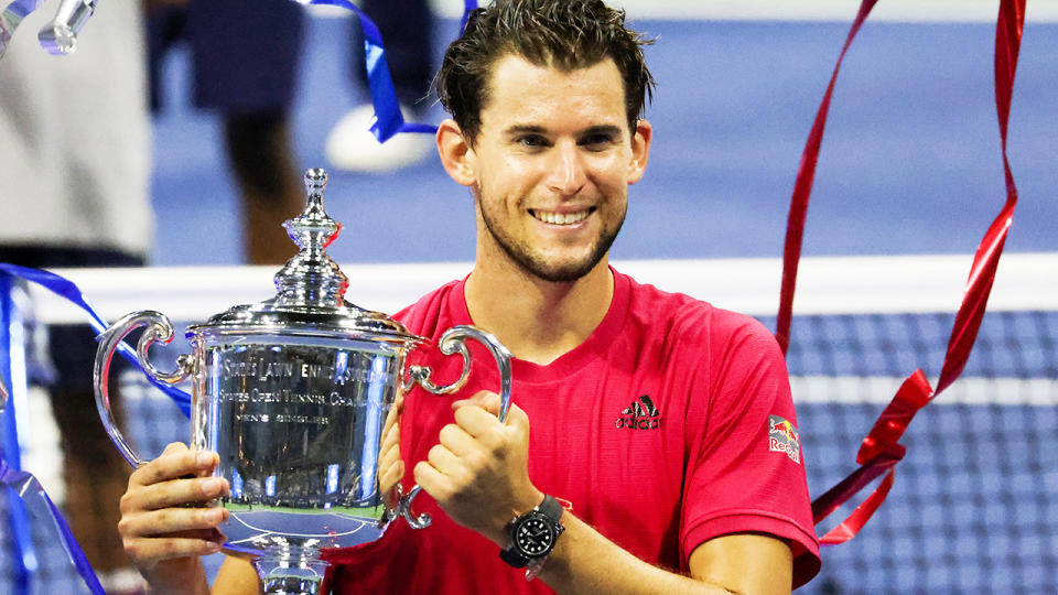 Dominic Thiem smiles and holds up the trophy after winning the US Open against Alexander Zverev.