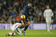 Valencia's Goncalo Guedes, centre, and Real Madrid's Lucas Vazquez vie for the ball during a Spanish La Liga soccer match between Real Madrid and Valencia at the Santiago Bernabeu stadium in Madrid, Spain, Saturday, Dec. 1, 2018. (AP Photo/Paul White)