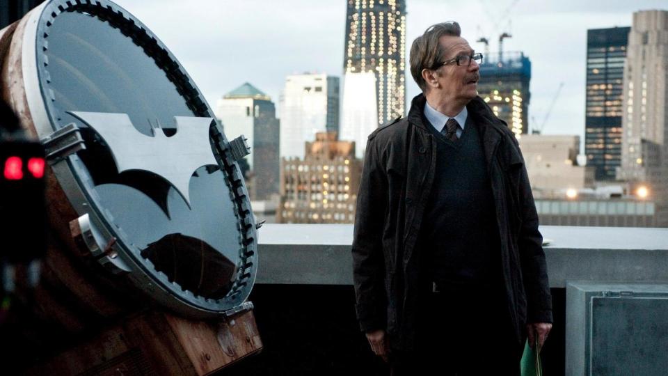 Gary Oldman in front of the Bat signal