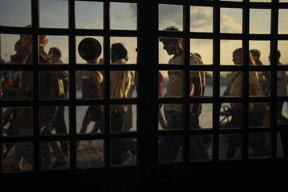 Commuters arrive at the Kadikoy ferry terminal after crossing the Bosphorus in Istanbul, Turkey, Friday, Sept. 8, 2023. (AP Photo/Francisco Seco)