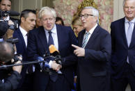 European Commission President Jean-Claude Juncker, center right, speaks with the media as he shakes hands with British Prime Minister Boris Johnson prior to a meeting at a restaurant in Luxembourg, Monday, Sept. 16, 2019. British Prime Minister Boris Johnson was holding his first meeting with European Commission President Jean-Claude Juncker on Monday in search of a longshot Brexit deal. (AP Photo/Olivier Matthys)