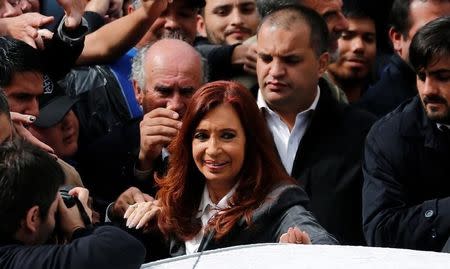 Former Argentine President Cristina Fernandez de Kirchner smiles as she leaves a Justice building where she attended court to answer questions over a probe into the sale of U.S. dollar futures contracts at below-market rates by the central bank during her administration, in Buenos Aires, Argentina, April 13, 2016. REUTERS/Marcos Brindicci