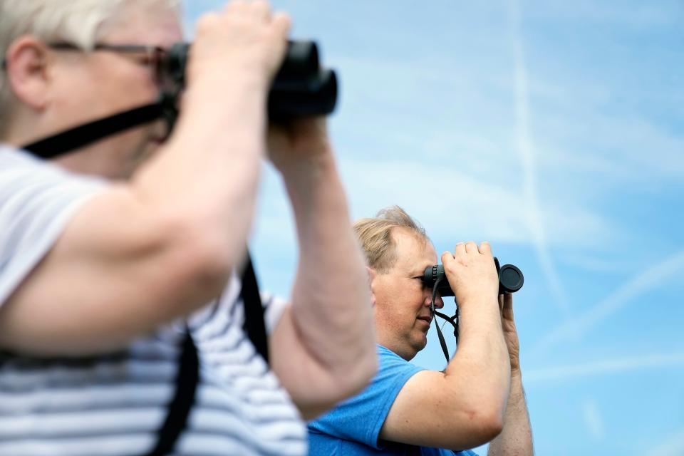 Guide Suzan Jervey, left, and Mark Schroeder, right, look for birds July 2 during a birdwatching for beginners course at Scioto Audubon Metro Park in Columbus.
