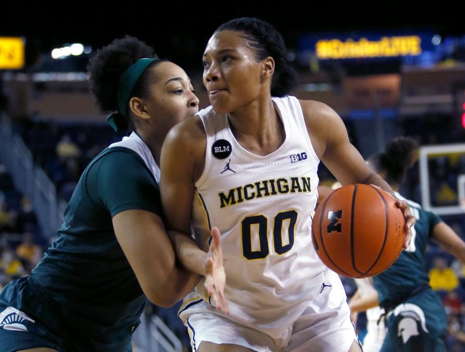 Michigan State forward Taiyier Parks, left, guards Michigan forward Naz Hillmon during the first half of an NCAA college basketball game Thursday, Feb. 24, 2022, in Ann Arbor, Mich.