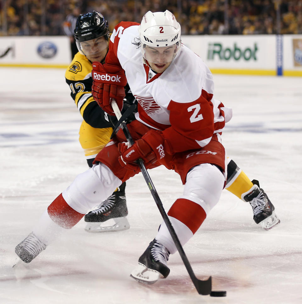 Detroit Red Wings defenseman Brendan Smith (2) tries to get away from Boston Bruins' Jarome Iginla during the second period of Game 1 of a first-round NHL playoff hockey series, in Boston on Friday, April 18, 2014. (AP Photo/Winslow Townson)