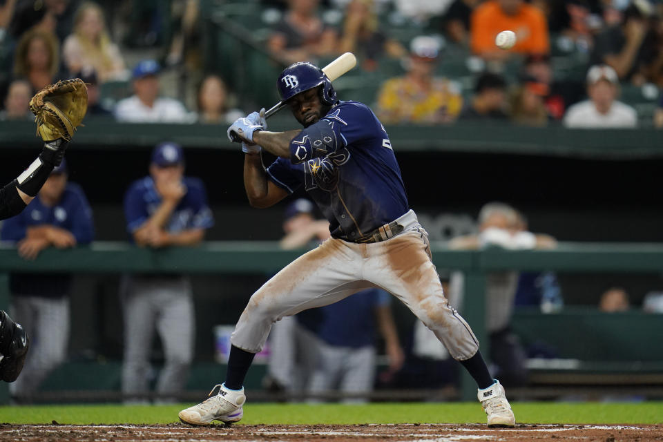 Tampa Bay Rays' Randy Arozarena ducks out of the way of a high pitch from Baltimore Orioles starting pitcher Spenser Watkins during the third inning of a baseball game, Tuesday, July 26, 2022, in Baltimore. (AP Photo/Julio Cortez)