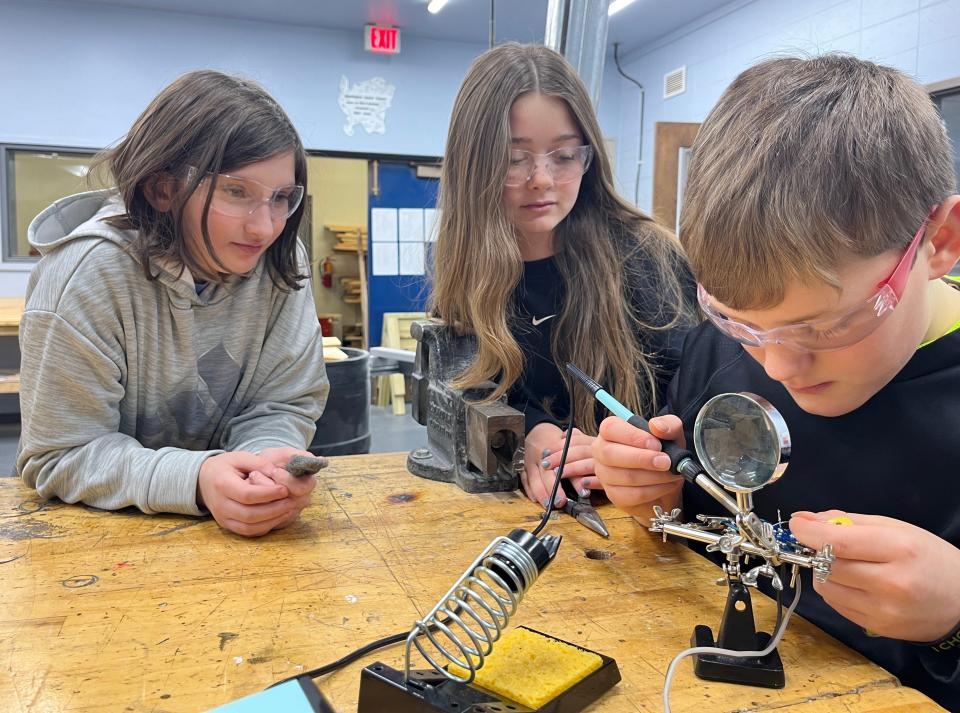 Washington Island students Tug, Kinsey and Marley work on a soldering project in the school district's existing fabrication laboratory, or "fab lab." The district recently received a $25,000 grant from the Wisconsin Economic Development Corp. to expand its fab lab.