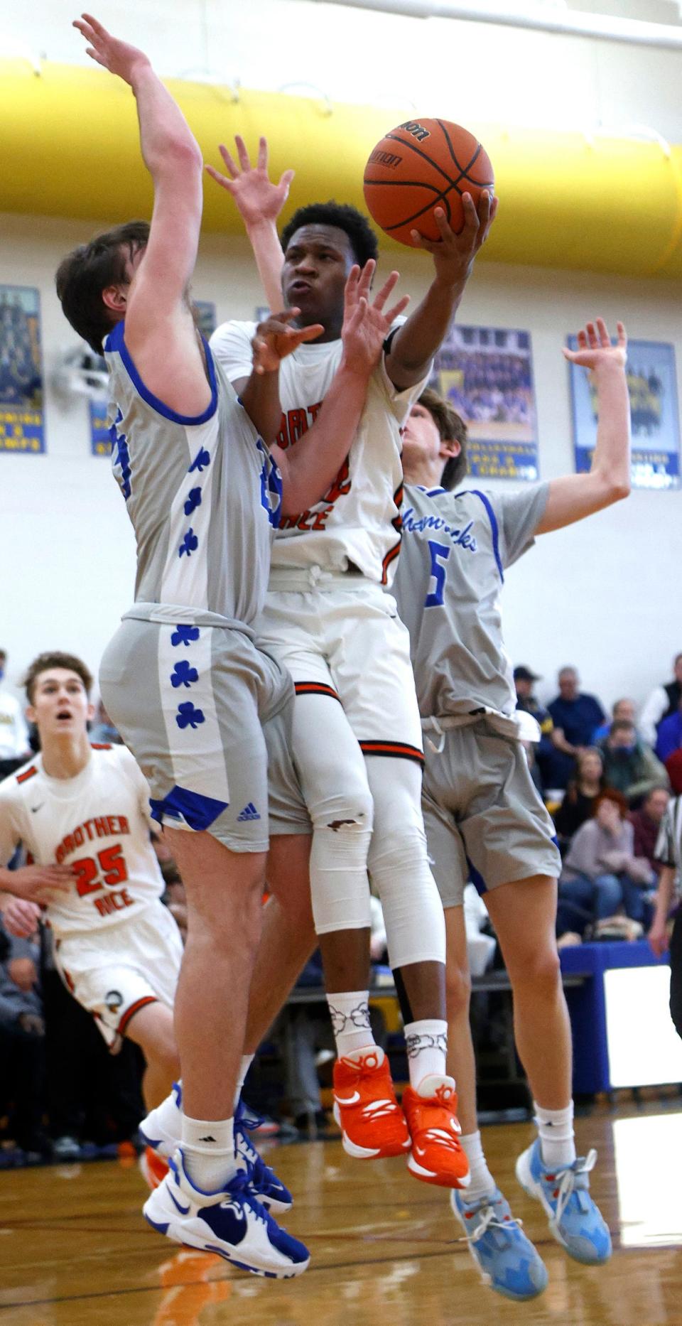 Birmingham Brother Rice's Curtis Williams drives towards the basket as Novi Detroit Catholic Central defends during CC's 66-64 win in the Catholic League quarterfinals at Birmingham Marian on Saturday, Feb. 19, 2022.