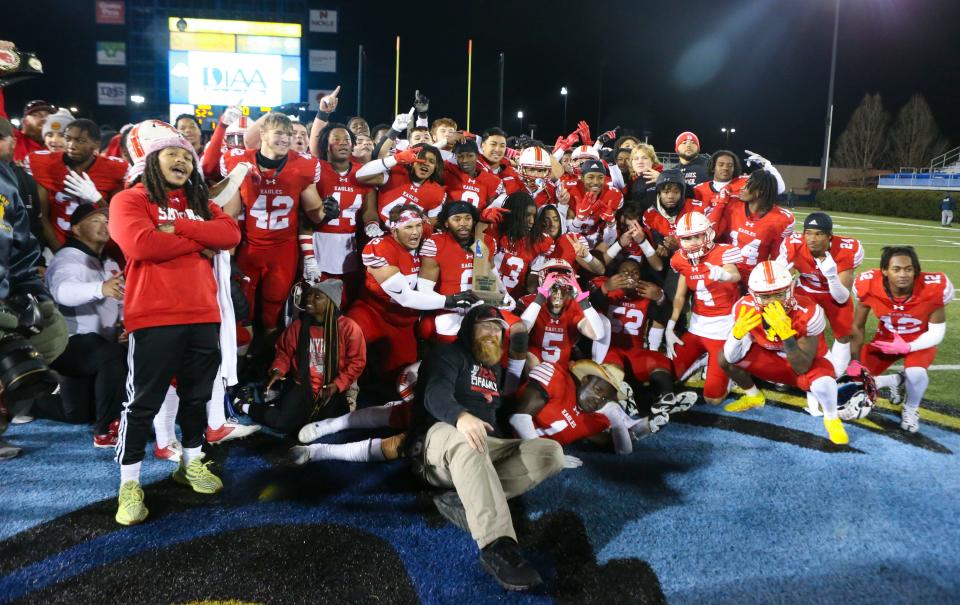 Smyrna poses with the championship trophy after the Eagles' 52-7 win in the DIAA Class 3A championship at Delaware Stadium, Saturday, Dec. 10, 2022.