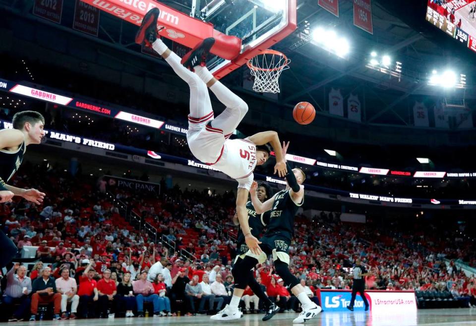 N.C. State’s Jack Clark (5) takes a hard fall after dunking the ball during N.C. State’s 90-74 victory over Wake Forest at PNC Arena in Raleigh, N.C., Wednesday, Feb. 22, 2023. Clark left the court after the fall and returned with his arm in a sling.