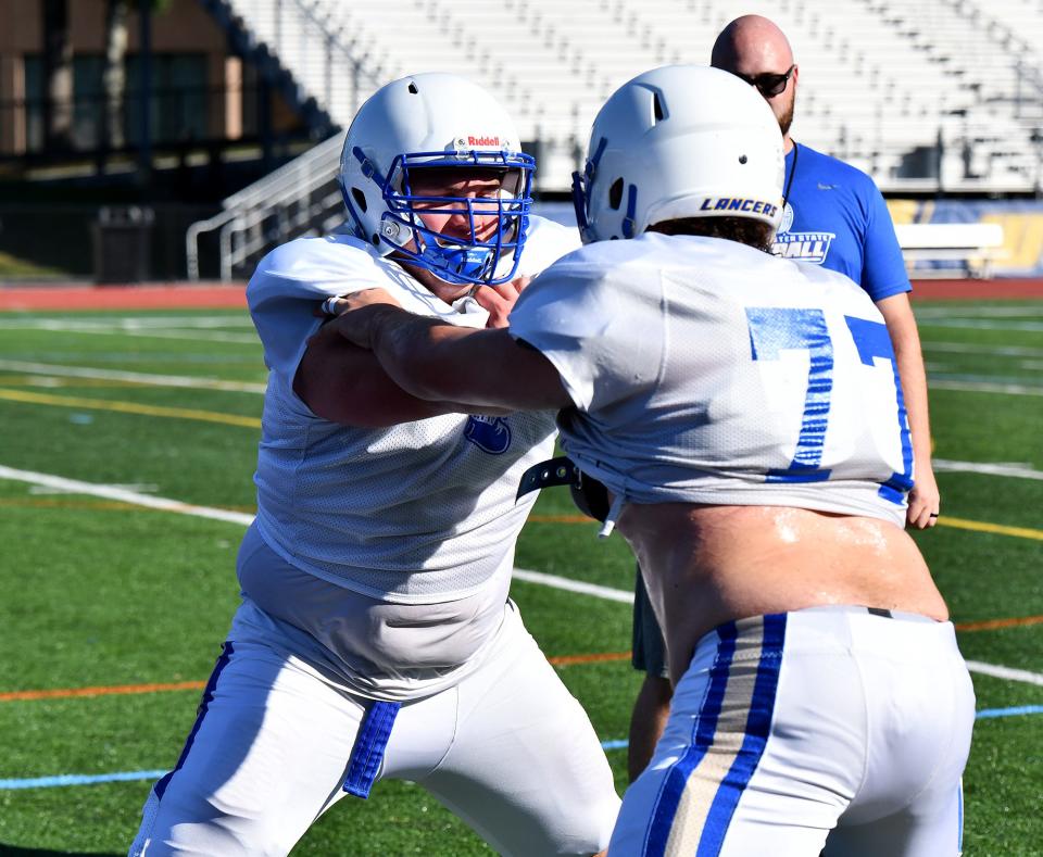 Worcester State senior offensive lineman Mike Mahoney, left, runs through a drill during a recent practice.