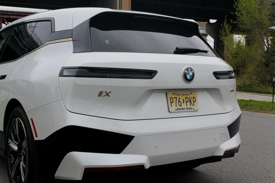 The 2022 BMW iX xDrive50's slim taillights seen from behind.