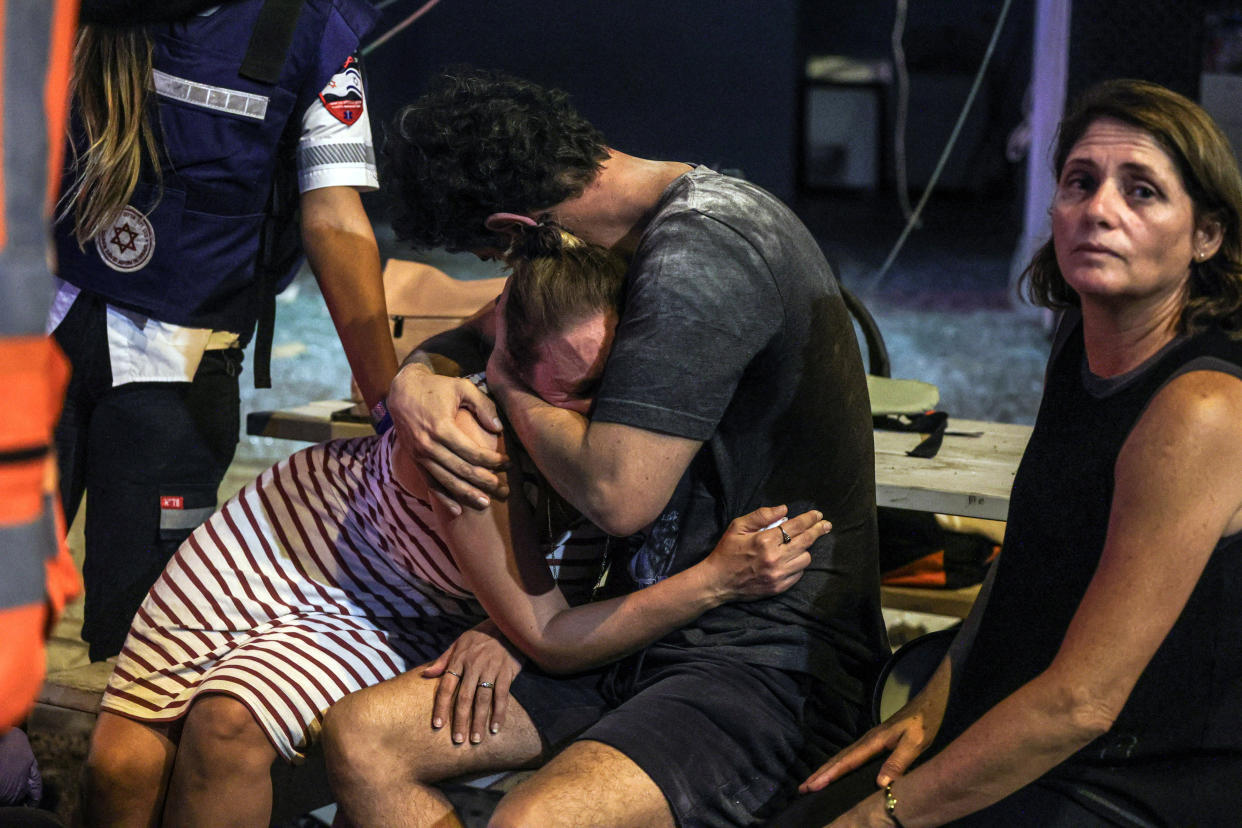 People at the site where a rocket launched from the Gaza Strip landed in Tel Aviv.