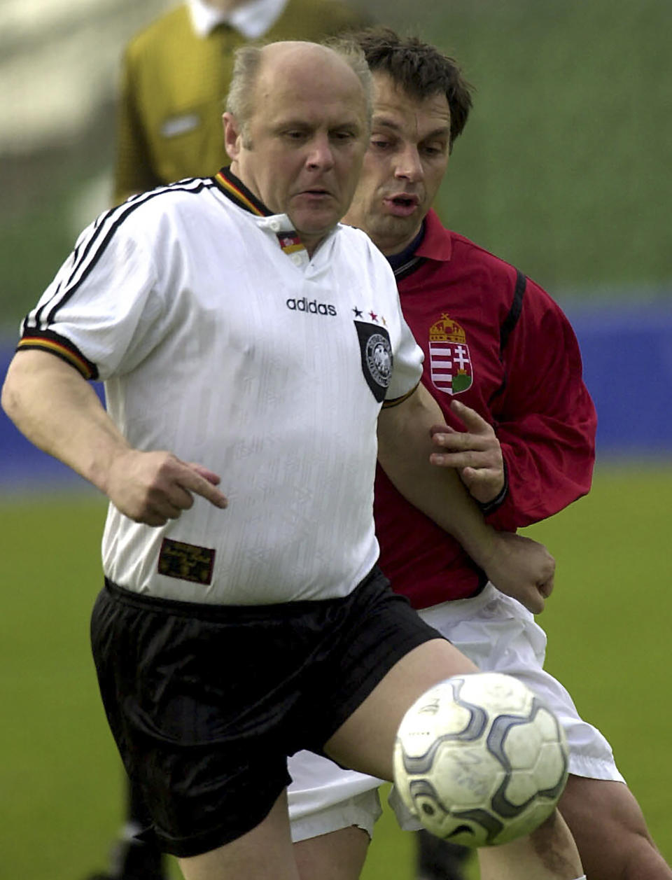 FILE - In this Tuesday April 24, 2001 file photo Hungarian Prime Minister Viktor Orban, right, and German lawmaker Heinz Schmitt fight for the ball during a friendly international soccer match between Hungarian Parliament and German Bundestag in Budapest. Populist Prime Minister Viktor Orban has long used soccer to advance his right-wing politics, and now widespread international criticism of a new Hungarian law that is seen as targeting the LGBT community has turned this month's Euro 2020 tournament into a major stage for his challenge to Europe's liberal values. (AP Photo/MTI, Szilard Koszticsak, File)