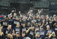 The New York Yankees pose for team photographs after defeating the Toronto Blue Jays in a baseball game to clinch the AL East, in Toronto on Tuesday, Sept. 27, 2022. (Nathan Denette/The Canadian Press via AP)