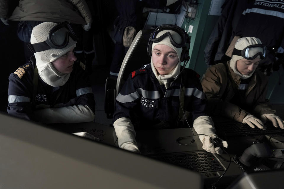 French sailors on the bridge of the French navy frigate Normandie keep watch as the vessel patrols in a Norwegian fjord, north of the Arctic circle, for a reconnaissance patrol, Wednesday March 6, 2024. The French frigate is part of a NATO force conducting exercises in the seas, north of Norway, codenamed Steadfast Defender, which are the largest conducted by the 31 nation military alliance since the cold war.(AP Photo/Thibault Camus)