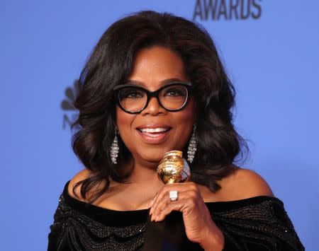 FILE PHOTO - 75th Golden Globe Awards – Photo Room – Beverly Hills, California, U.S., 07/01/2018 – Oprah Winfrey poses backstage with her Cecil B. DeMille Award. REUTERS/Lucy Nicholson