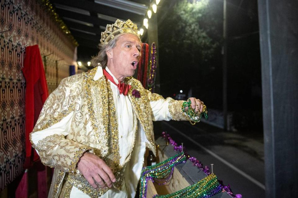 A member of a krewe throws beads during a Twelfth Night celebration in Biloxi on Thursday, Jan. 5, 2023.