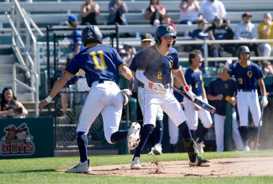 Gregori’s Izaia Perez (2) and Clayton Durrer celebrate a run during the Modesto Nuts High School Baseball Showcase game with Central Catholic at John Thurman Field in Modesto, Calif., Saturday, March 16, 2024.