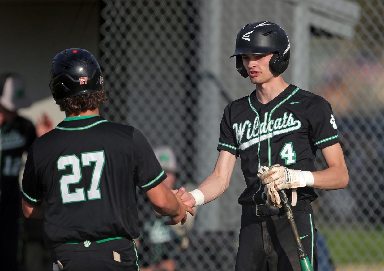 Mogadore's Tanner Buso, facing, celebrates with Austin Constantine after he scored during the fifth inning of a high school baseball game against Garfield, Wednesday, May 1, 2024, in Garrettsville, Ohio.