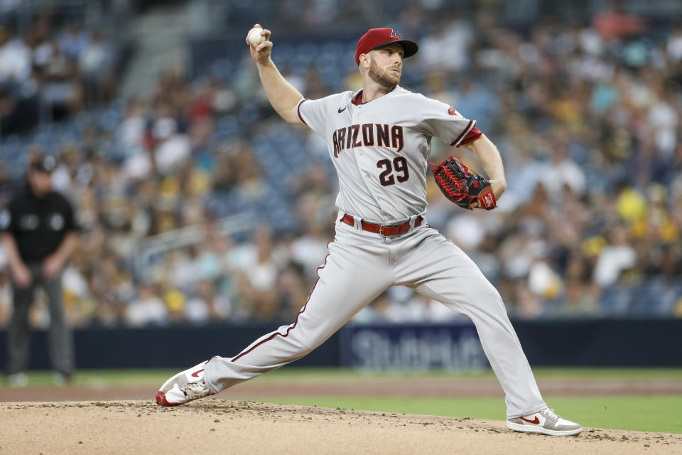 Arizona Diamondbacks starting pitcher Merrill Kelly (29) throws to the plate during the first inning of a baseball game against the Arizona Diamondbacks Tuesday, Sept. 6, 2022, in San Diego. (AP Photo/Brandon Sloter)