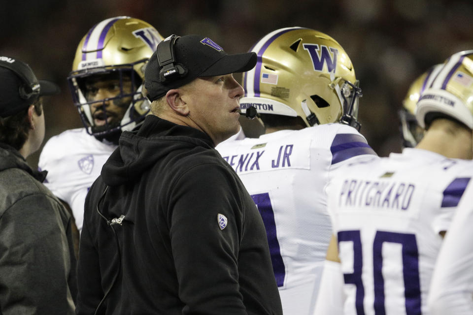 Washington head coach Kalen DeBoer, center, stands near his team during a break in play in the first half of an NCAA college football game against Washington State, Saturday, Nov. 26, 2022, in Pullman, Wash. (AP Photo/Young Kwak)