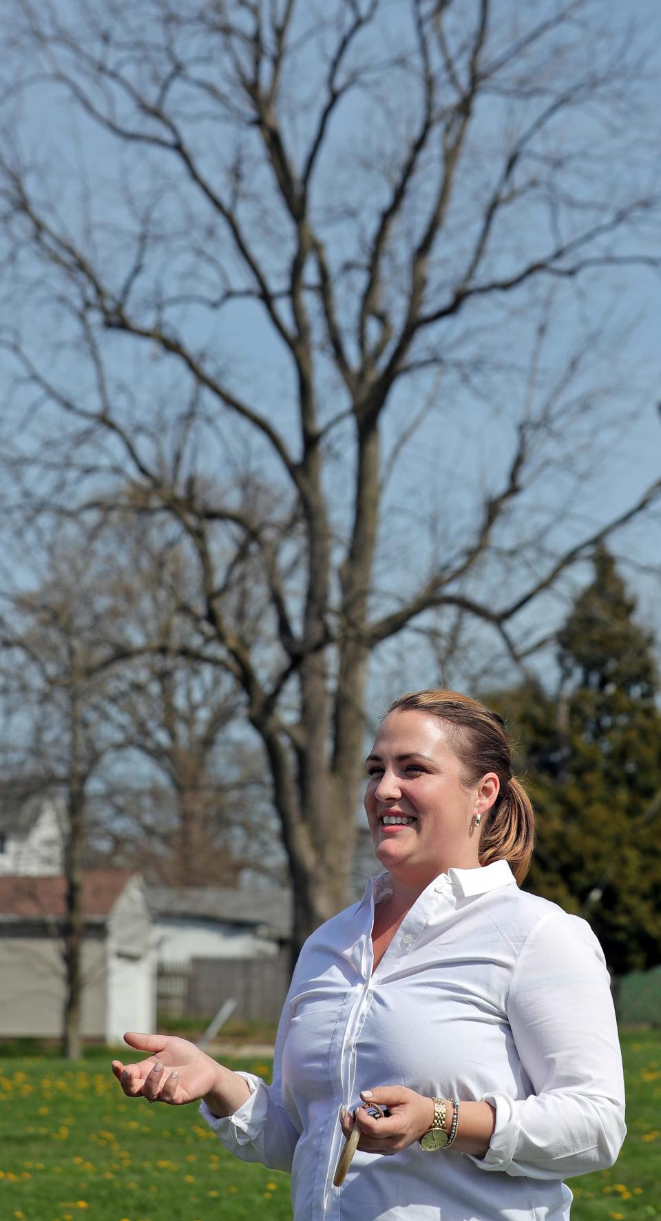 Leah Heiser, Keep Akron Beautiful's flowerscape director and arborist, discusses the benefits of planting new trees citywide April 16 near Voris Elementary School in Akron.