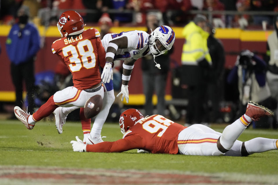 Buffalo Bills wide receiver Stefon Diggs (14) is unable to catch a pass as Kansas City Chiefs cornerback L'Jarius Sneed (38) and defensive tackle Tershawn Wharton (98) defend during the second half of an NFL football game Sunday, Dec. 10, 2023, in Kansas City, Mo. (AP Photo/Charlie Riedel)