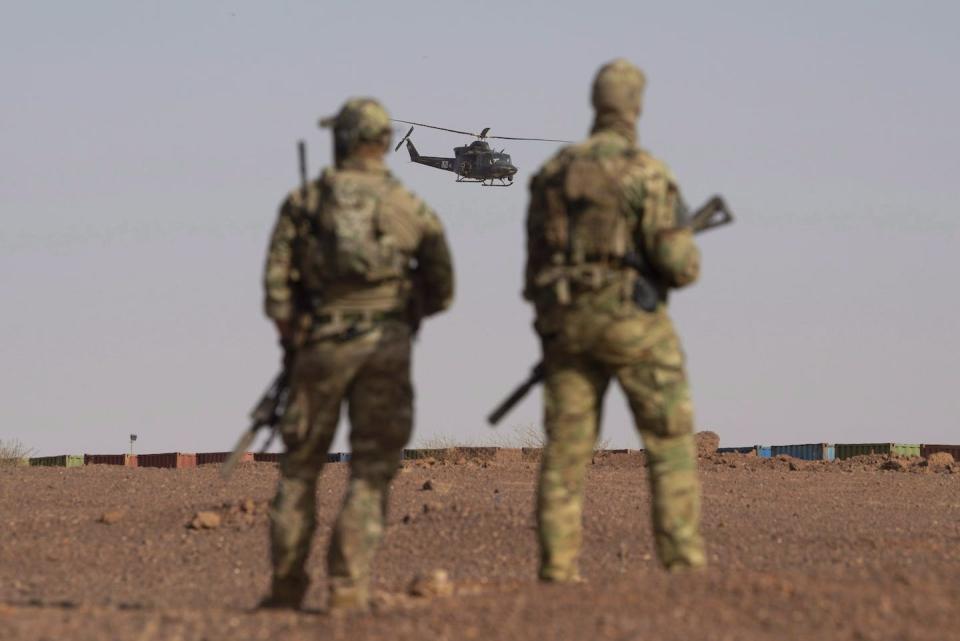 Canadian soldiers watch as a Canadian helicopter provides air security during a demonstration for Prime Minister Justin Trudeau on the United Nations base in Gao, Mali in December 2018. THE CANADIAN PRESS/Adrian Wyld