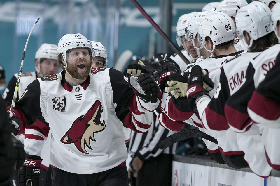 FILE- In this May 7, 2021, file photo, Arizona Coyotes right wing Phil Kessel (81) celebrates at the bench after scoring a goal against the San Jose Sharks during the third period of an NHL hockey game in San Jose, Calif. (AP Photo/Tony Avelar, File)