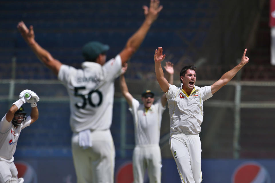 Australia's Pat Cummins, right, and teammates appeal LWB out against Pakistan Imam-ul-Haq on the third day of the second test match between Pakistan and Australia at the National Stadium in Karachi, Pakistan, Monday, March 14, 2022. (AP Photo/Anjum Naveed)