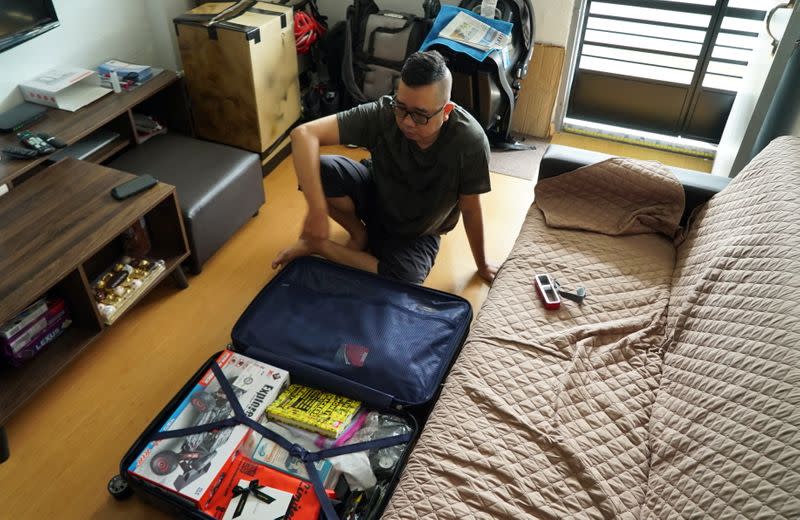 Singaporean Mohammad Faris Abdullah, 37, packs his luggage ahead of his trip back to Malaysia after being separated from his family for two years amid the COVID-19 pandemic, in Singapore