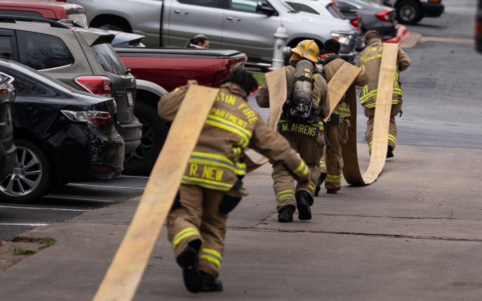 Austin firefighters respond to a blaze at the Casulo Hotel near Interstate 35 South and Oltorf Street in February. Firefighters have higher rates of PTSD and suicide than the general population, according to a 2022 study.