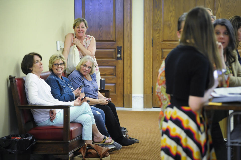 A group of women occupy the bench Rep. Zooey Zephyr, D-Missoula, was working from outside the House of Representatives chamber in the Montana State Capitol in Helena, Mont., on Monday, May 1, 2023. (Thom Bridge/Independent Record via AP)