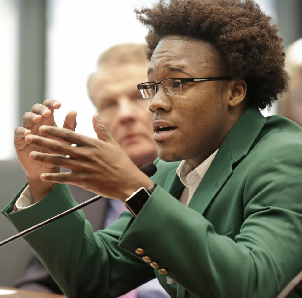 Dennis Johnson, Student Government Association President at Chicago State University, right, and Illinois House Speaker Michael Madigan, appear before an Illinois House committee meeting, Thursday, April 17, 2014, in Chicago, regarding a plan to devote $100 million in state funds to help bring President Barack Obama's presidential museum and library to Chicago. Madigan, and Mayor Rahm Emanuel were among several officials who spoke in favor of the funding. The $100 million for construction costs would be part of a new capital construction plan, which the Legislature still must approve. (AP Photo/M. Spencer Green)