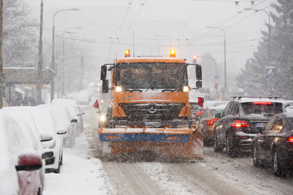 Snowplow clears a road covered by the snow during heavy snowfall in Bratislava, Slovakia, Tuesday, Jan. 8, 2019. Cold weather has engulfed many parts of Europe Tuesday. (Jaroslav Novak/TASR via AP)