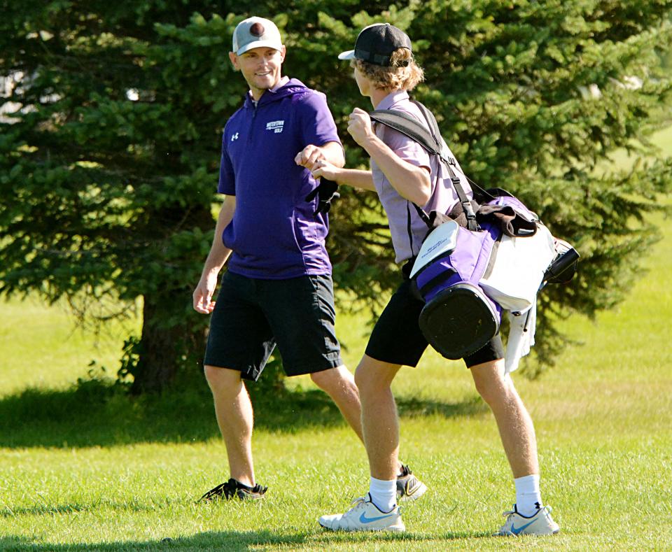 Watertown head coach Corey Neale (left) gives a fist bump to Brody Torgerson during the Watertown Invitational boys golf tournament recently, will lead the Arrows into the state Class AA tournament on Monday and Tuesday, Oct. 3-4, 2022 at the Lakeview Golf Course in Mitchell. The Arrows hope to male a run at their first state title since 1971.