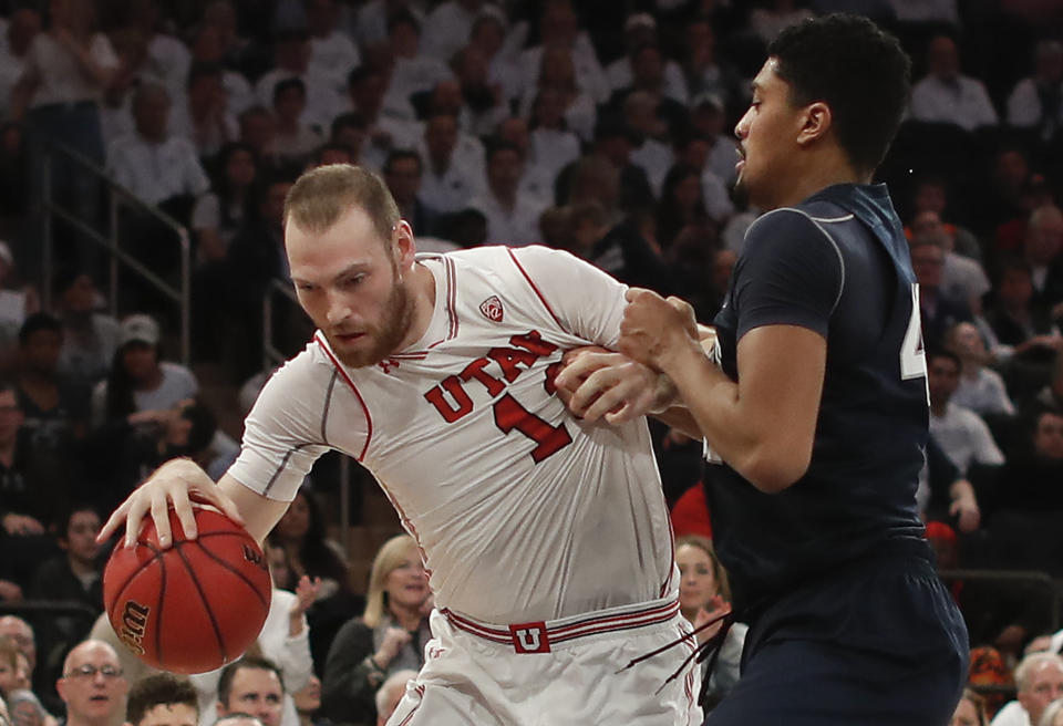 Utah forward David Collette (13) drives against Penn State forward Julian Moore (44) during the first quarter of an NCAA college basketball game for the NIT championship Thursday, March 29, 2018, in New York. (AP Photo/Julie Jacobson)