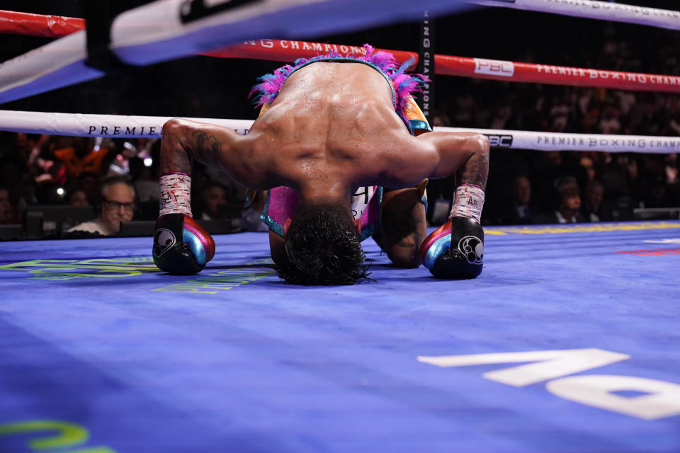 Mario Barrios falls to the ground after Gervonta Davis hits him during the WBA Super Lightweight world championship boxing match on Sunday, June 27, 2021, in Atlanta. Davis won. (AP Photo/Brynn Anderson)