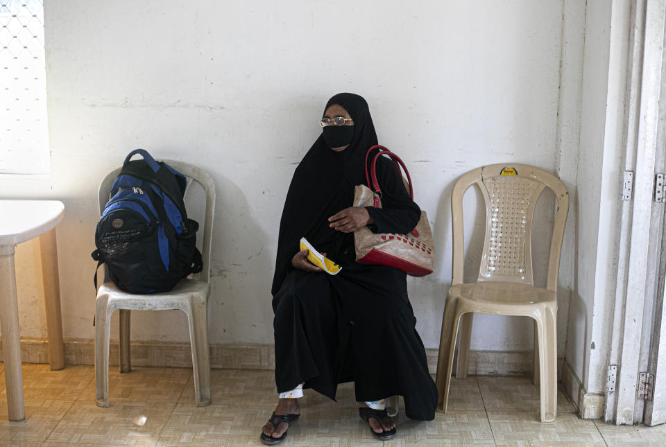 A woman waits to test for COVID-19 during a random test for the family members of army personnel at the army base hospital in Gauhati, India, Monday, Oct. 19, 2020. (AP Photo/Anupam Nath)