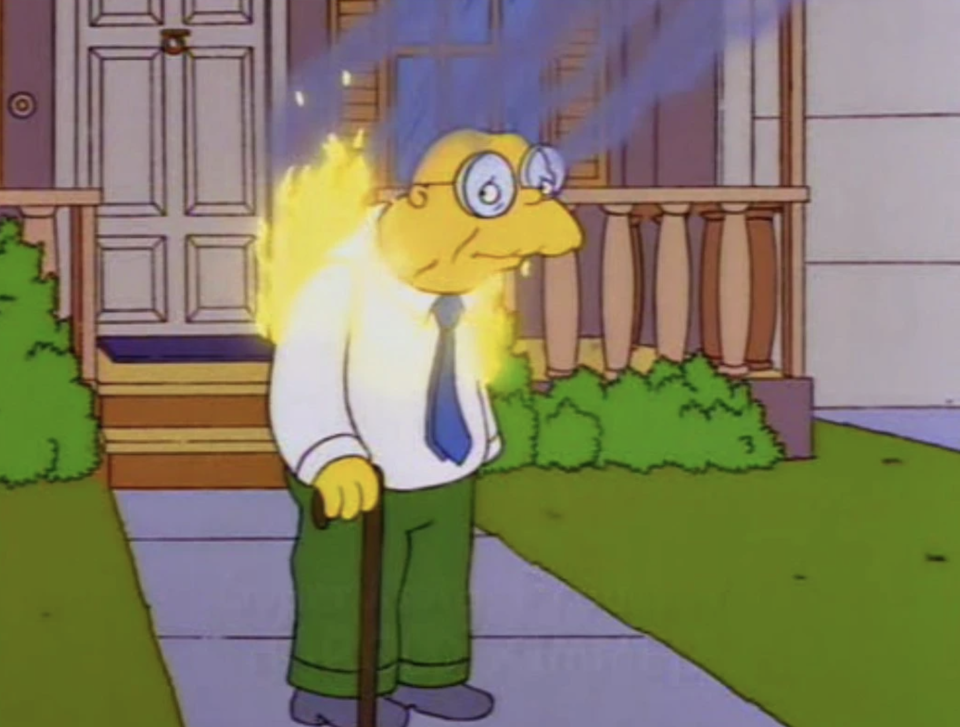 Hans Moleman stands in front of a house, and he's on fire