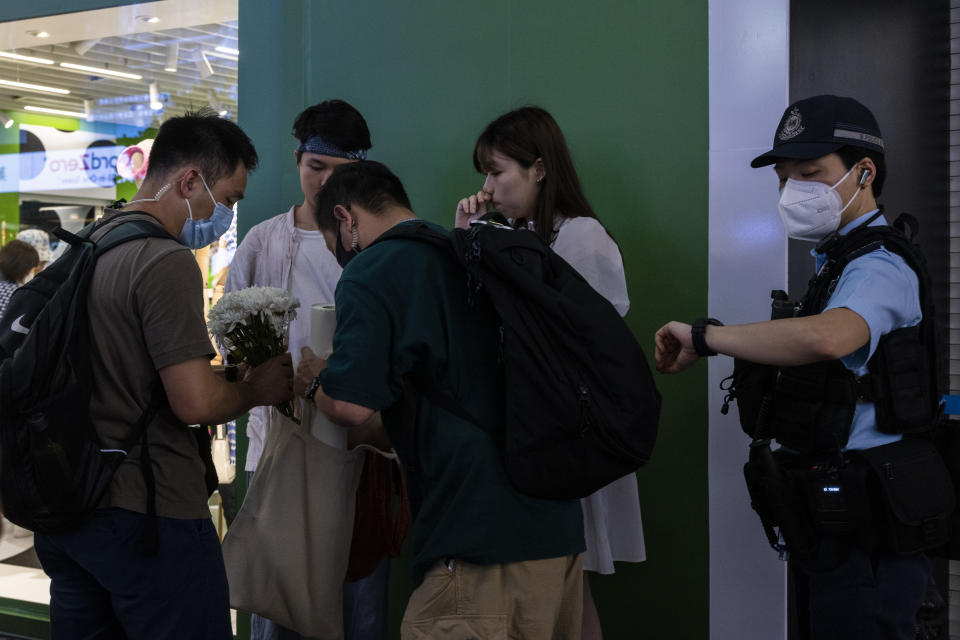 Police officers conduct a search on a member of the public in the Causeway Bay area on the eve of the 34th anniversary of China's Tiananmen Square massacre, in Hong Kong, Saturday, June 3, 2023. (AP Photo/Louise Delmotte)