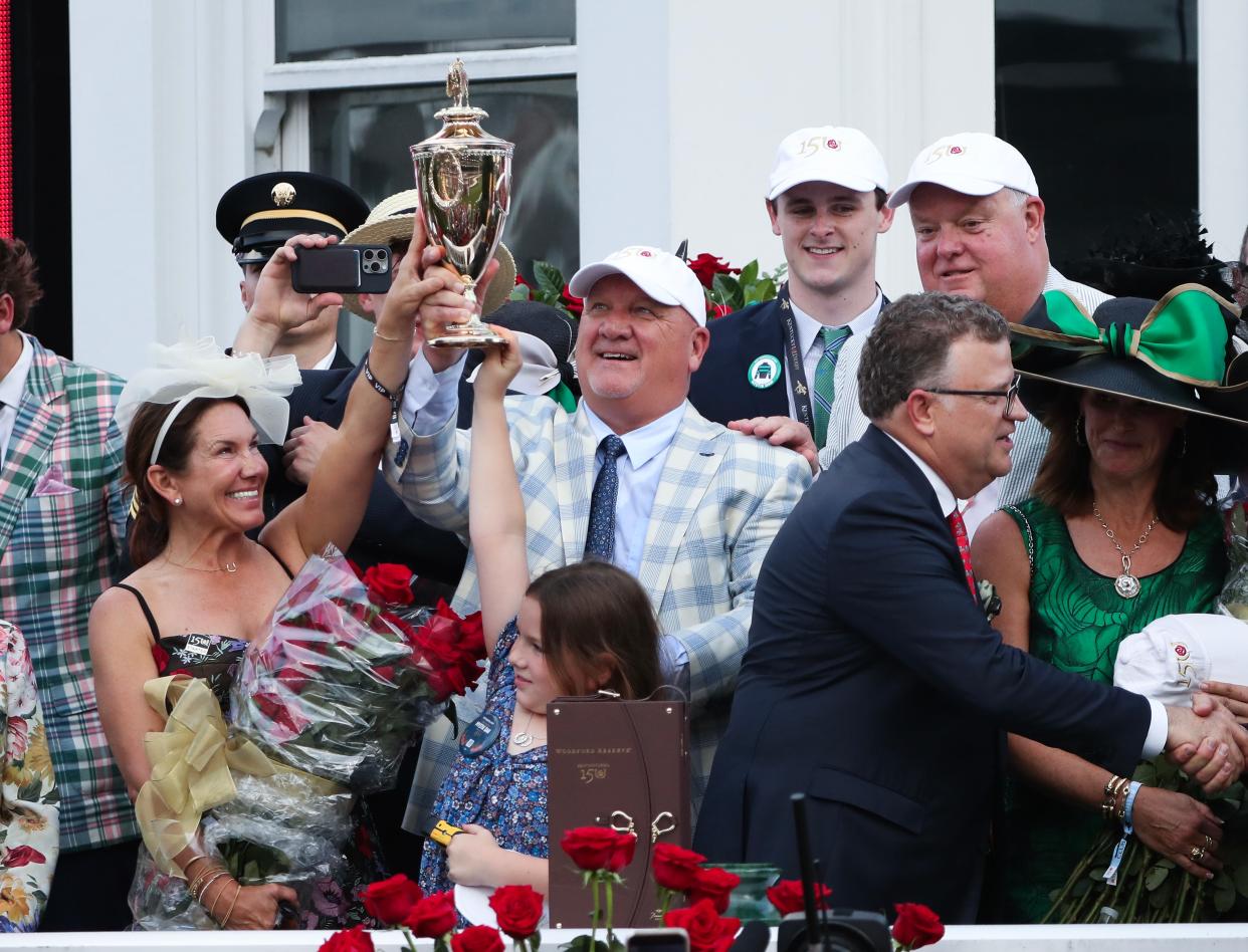 Mystik Dan trainer Kenny McPeek, center, celebrated in the winners circle after they won a photo finish at the Kentucky Derby in Louisville, Ky. on May. 4 2024.