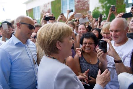 German Chancellor Angela Merkel meets visitors during the open day at the Federal Chancellery in Berlin, Germany August 28, 2016. REUTERS/Stefanie Loos