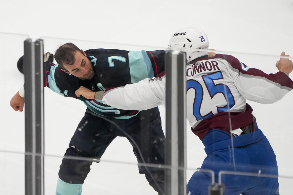 Seattle Kraken right wing Jordan Eberle (7) and Colorado Avalanche right wing Logan O'Connor (25) fight during the first period of an NHL hockey game Tuesday, Oct. 17, 2023, in Seattle. (AP Photo/Lindsey Wasson)