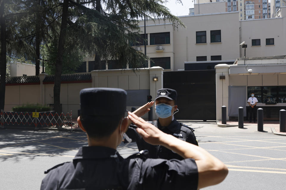 Chinese SWAT officers salute each other at the former United States Consulate in Chengdu in southwest China's Sichuan province on Monday, July 27, 2020. Chinese authorities took control of the former U.S. consulate in the southwestern Chinese city on Monday after it was ordered closed amid rising tensions between the global powers.(AP Photo/Ng Han Guan)