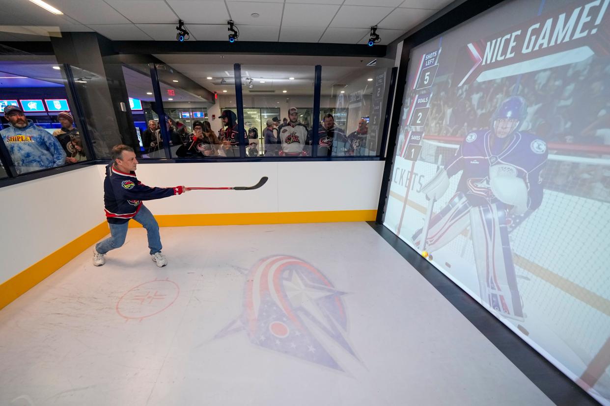 Rich Canary of Hilliard shoots in a virtual goalie game inside the new Fan Zone prior to the NHL hockey game between the Columbus Blue Jackets and the San Jose Sharks at Nationwide Arena on Jan. 21.