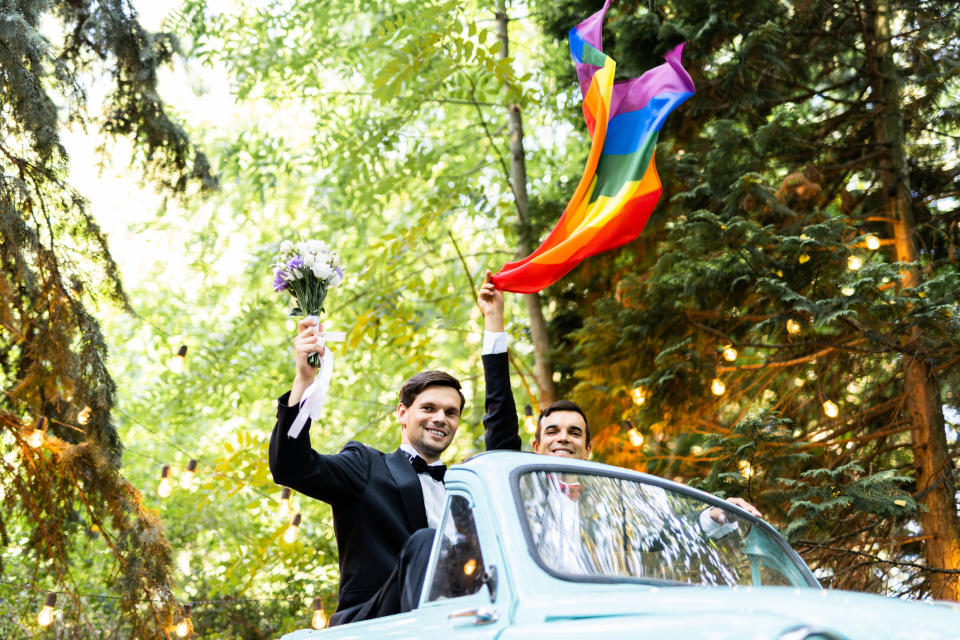 a couple leaving their wedding in a convertible